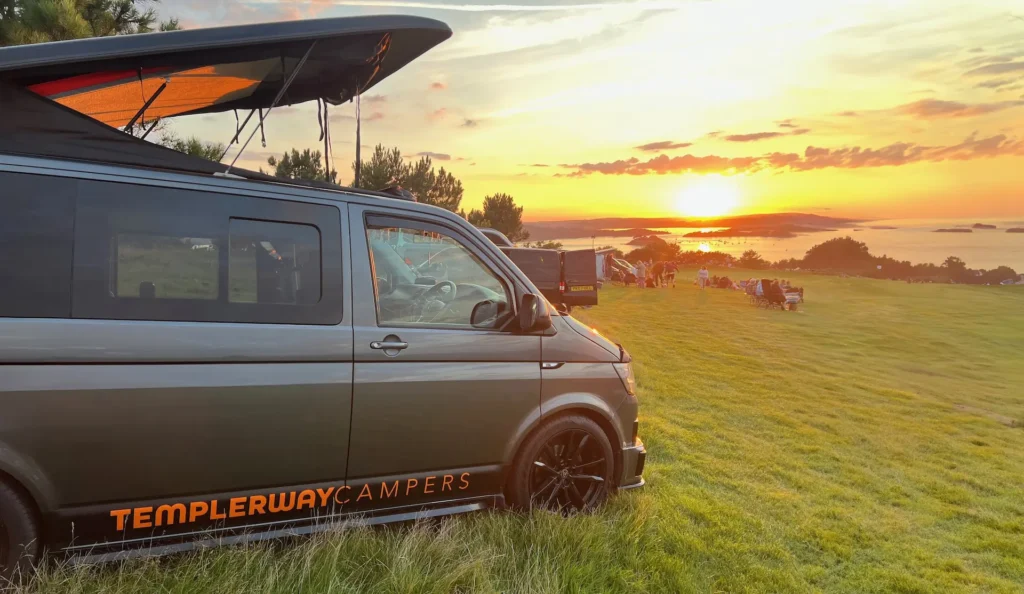a van conversion at a campsite at sunset in devon