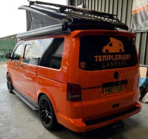 templer way camper's orange vw demo camper van in their workshop with a pop top roof installation